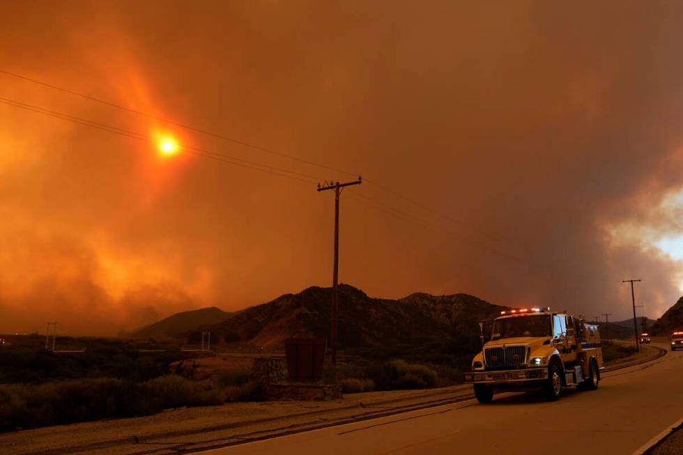 Emergency vehicles head toward the Post Fire Saturday, June 15, 2024, in Gorman, Calif. (AP Pho ...