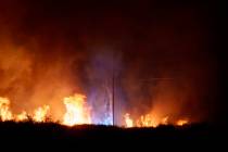 Power lines spark as a pole burns during the Post Fire on Saturday, June 15, 2024, in Gorman, C ...
