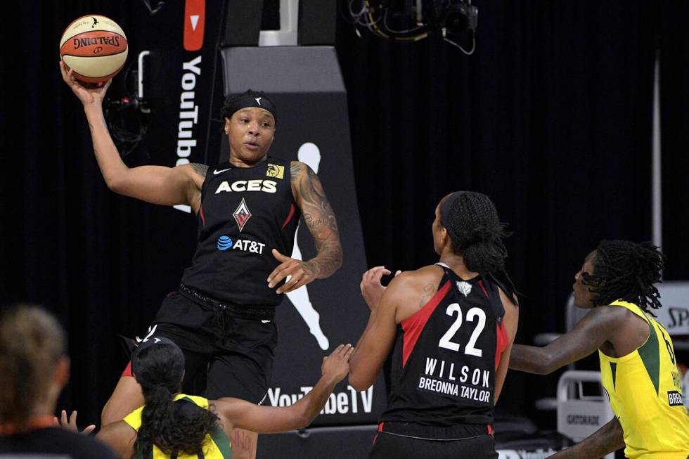 Las Vegas Aces forward Emma Cannon, top left, passes the ball to center A'ja Wilson (22) as Sea ...