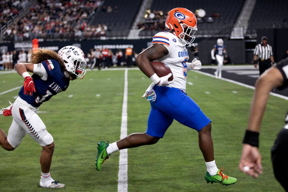 Bishop Gorman wide receiver Elija Lofton (9) runs the ball in for a touchdown followed by Liber ...