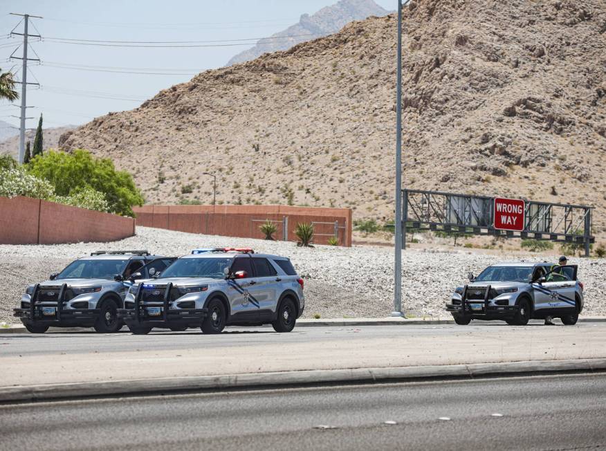 Police at the scene where a woman died in a single car fatal crash near the 215 Beltway in Las ...