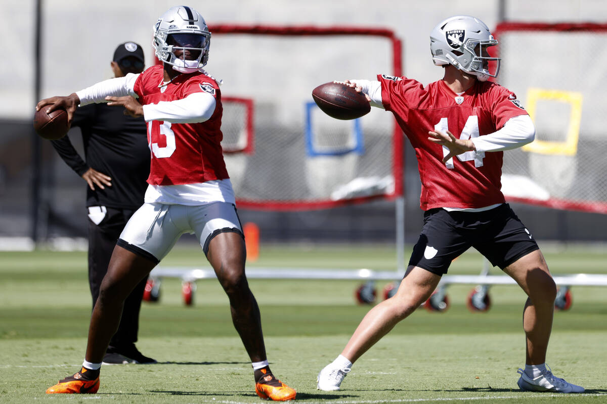 Raiders quarterbacks Anthony Brown Jr. (13) and Carter Bradley (14) prepare to throw the ball d ...