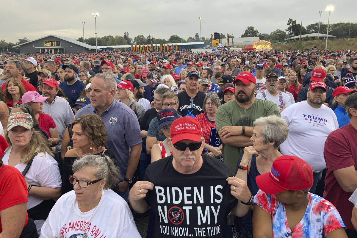 People gather ahead of an appearance by former President Donald Trump. (AP Photo/Thomas Beaumont)