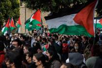 Pro-Palestinian demonstrators listens to a speaker as they protest at Stanford University urgin ...