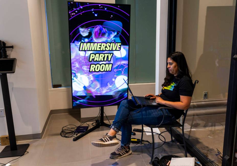 Financial Controller Patricia Garrett sets up an electronic reader board near the entrance at E ...