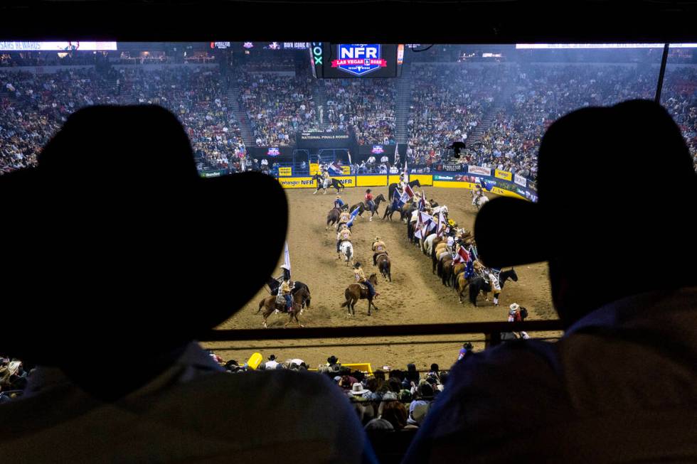 Rodeo fans look on as the competitors enter the ring during the National Finals Rodeo Day 4 at ...