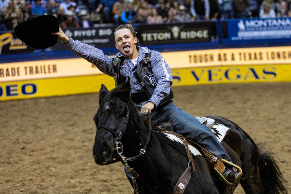 Logan Hay, of Wildwood, Alberta, Canada, celebrates after winning in the saddle bronc riding co ...