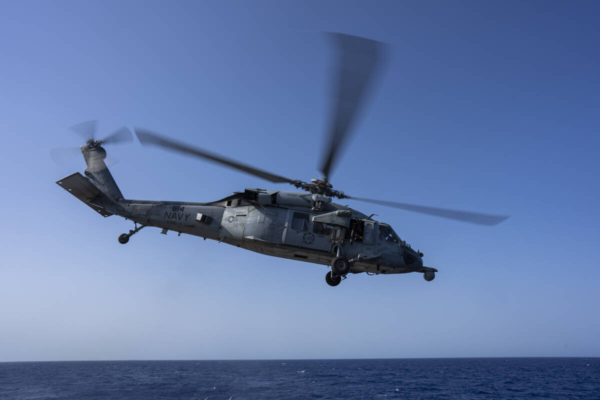 An HSC-7 helicopter flies toward the USS Dwight D. Eisenhower in the Red Sea on Wednesday, June ...
