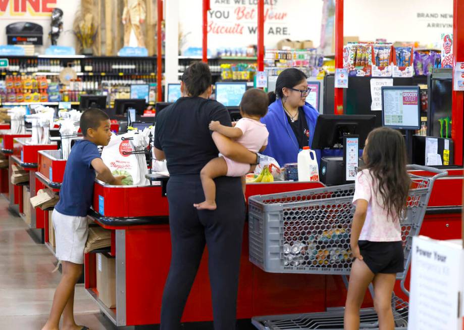 Heather Rodriguez, right, helps shoppers to checkout at Grocery Outlet Bargain Market, on Wedne ...