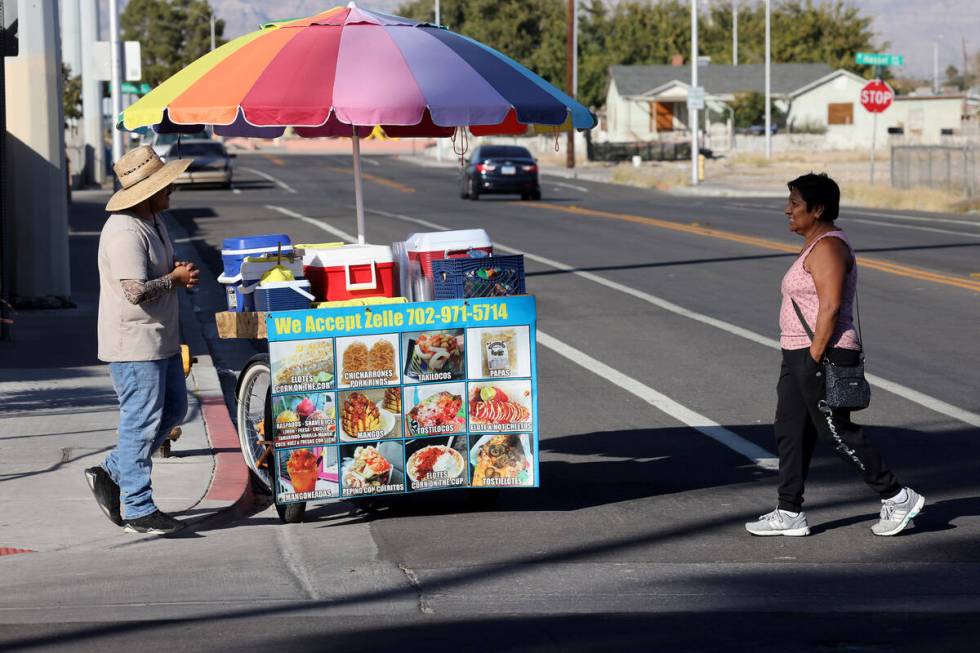 Street vendor Luis Serrano serves customers in the Historic Westside in Las Vegas Tuesday, Nov. ...