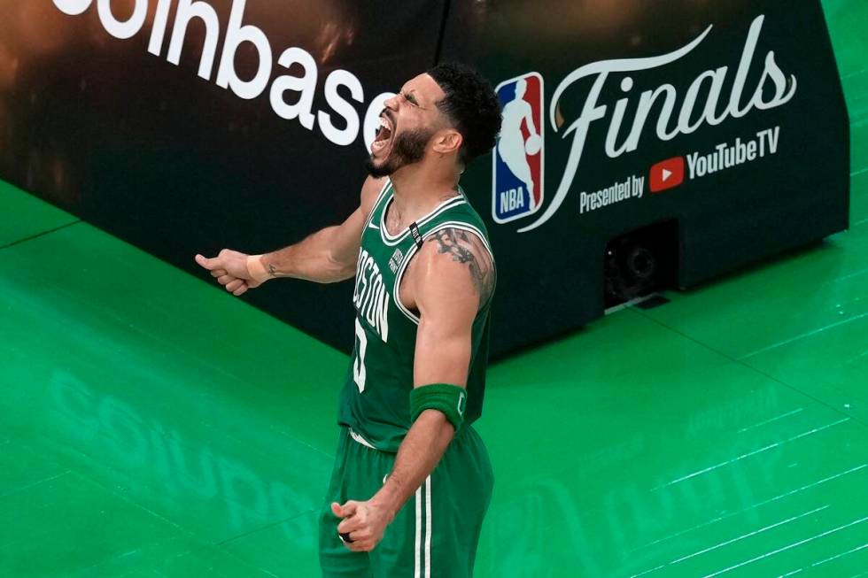 Boston Celtics' Jayson Tatum celebrates after scoring during the first half of Game 5 of the NB ...