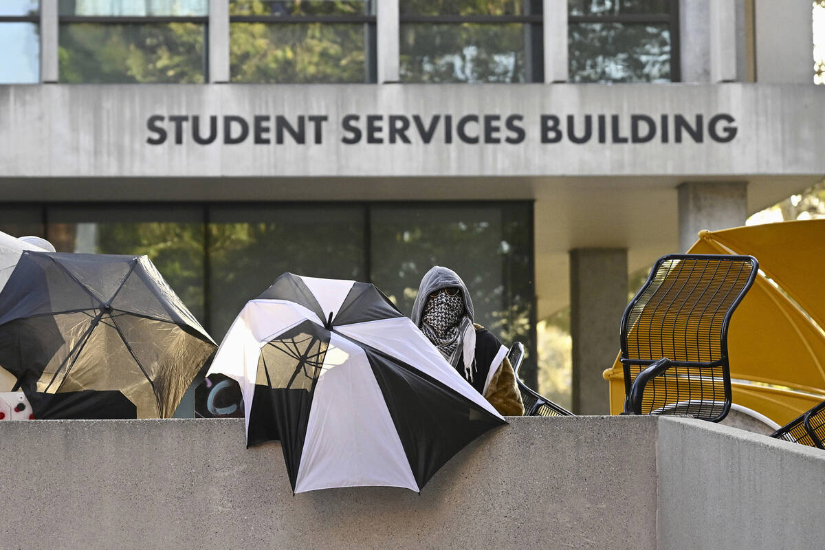 FILE - Pro-Palestinian student protesters barricade the entrance to the student services buildi ...