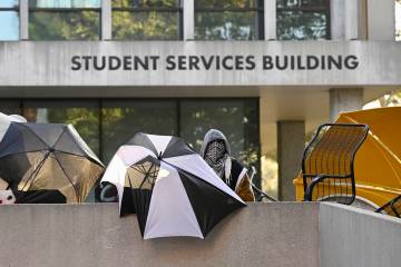 FILE - Pro-Palestinian student protesters barricade the entrance to the student services buildi ...