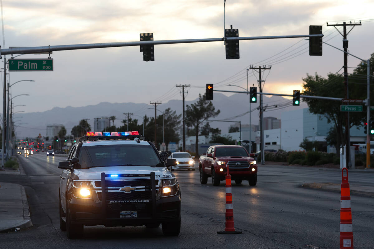 A Metropolitan police care is parked on East Charleston Boulevard near Pecos Avenue as officers ...