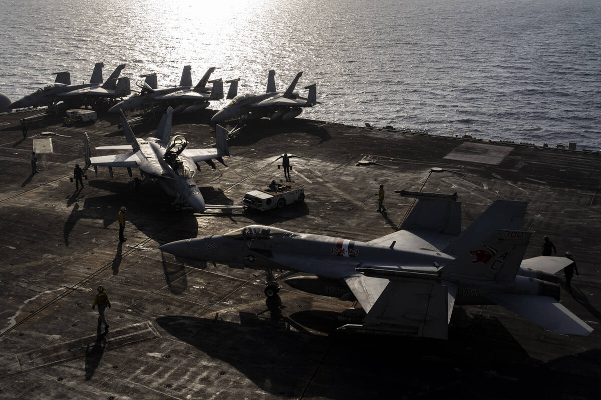 Figther jets maneuver on the deck of the USS Dwight D. Eisenhower in the Red Sea on Tuesday, Ju ...