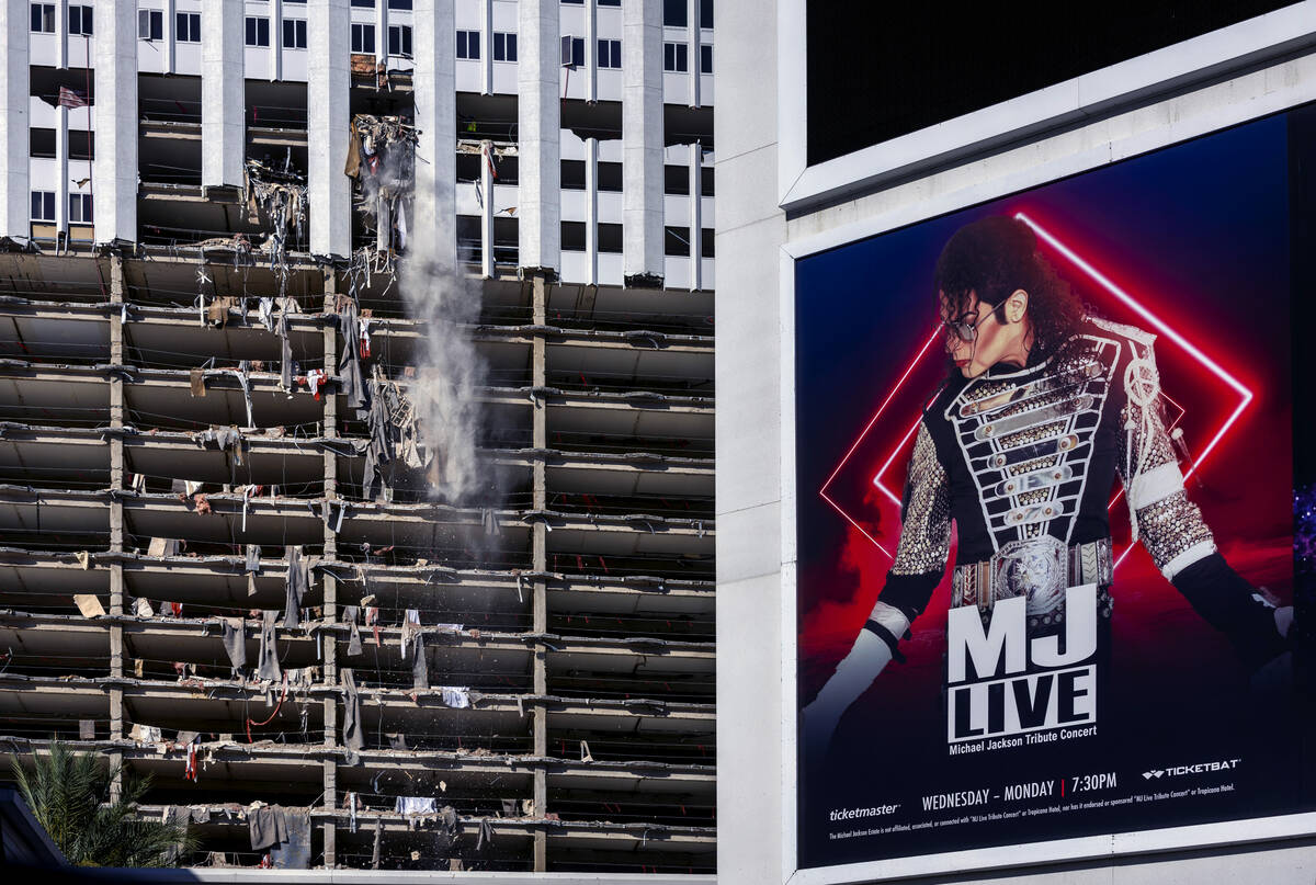 An old ad for MJ Live remains on the marquis as debris is pushed out of a higher floor of the t ...