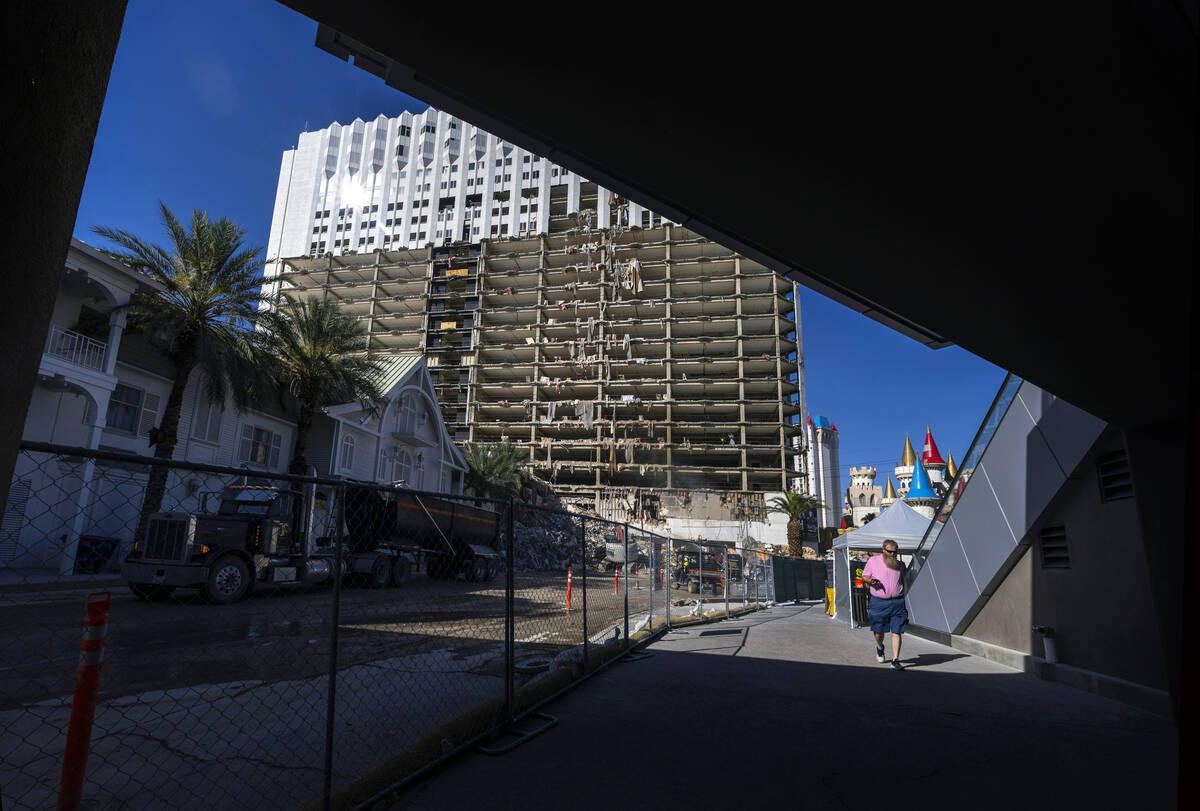 A pedestrian walks beneath a bridge as demolition continues on the Tropicana in preparation for ...