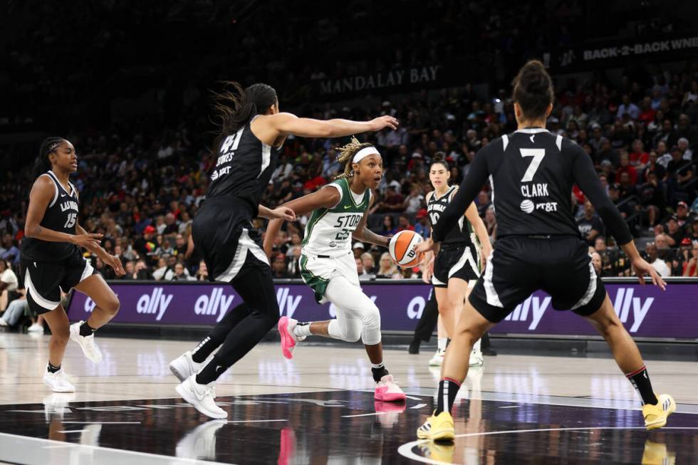 Seattle Storm guard Jordan Horston (23) drives toward the hoop against Las Vegas Aces center Ki ...