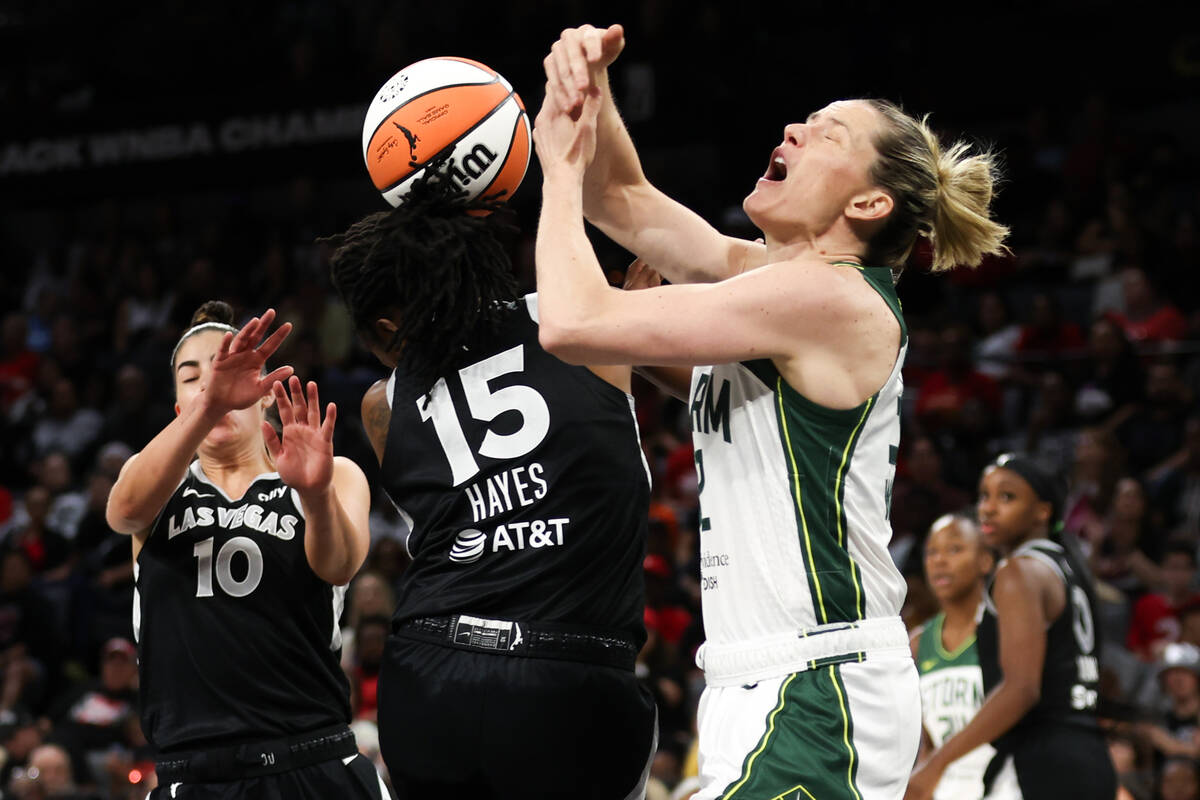 Las Vegas Aces guard Tiffany Hayes (15) steals the ball from Seattle Storm guard Sami Whitcomb, ...