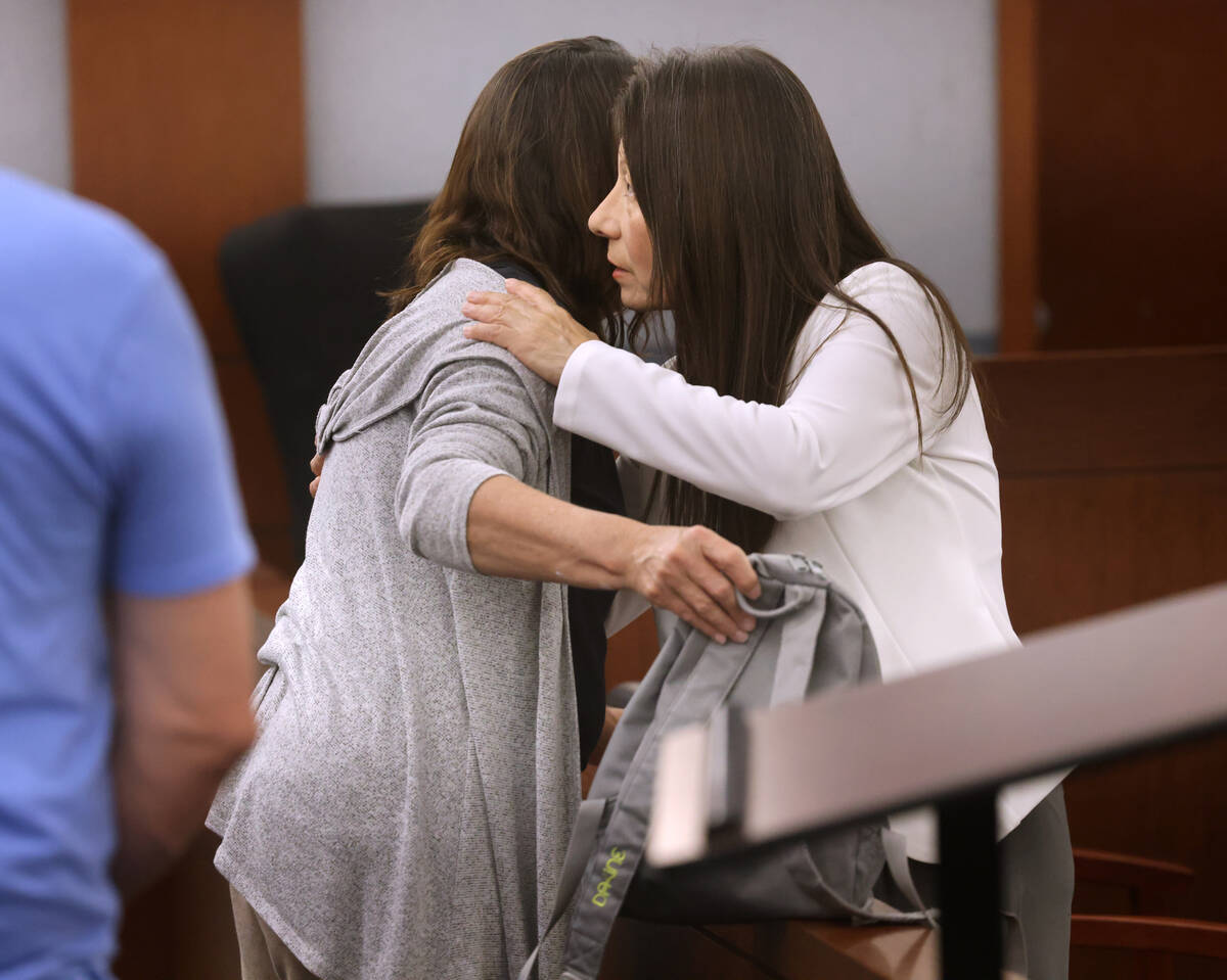 Pamela Bordeaux, 60, right, passes personal belongings to a loved one before being remanded int ...