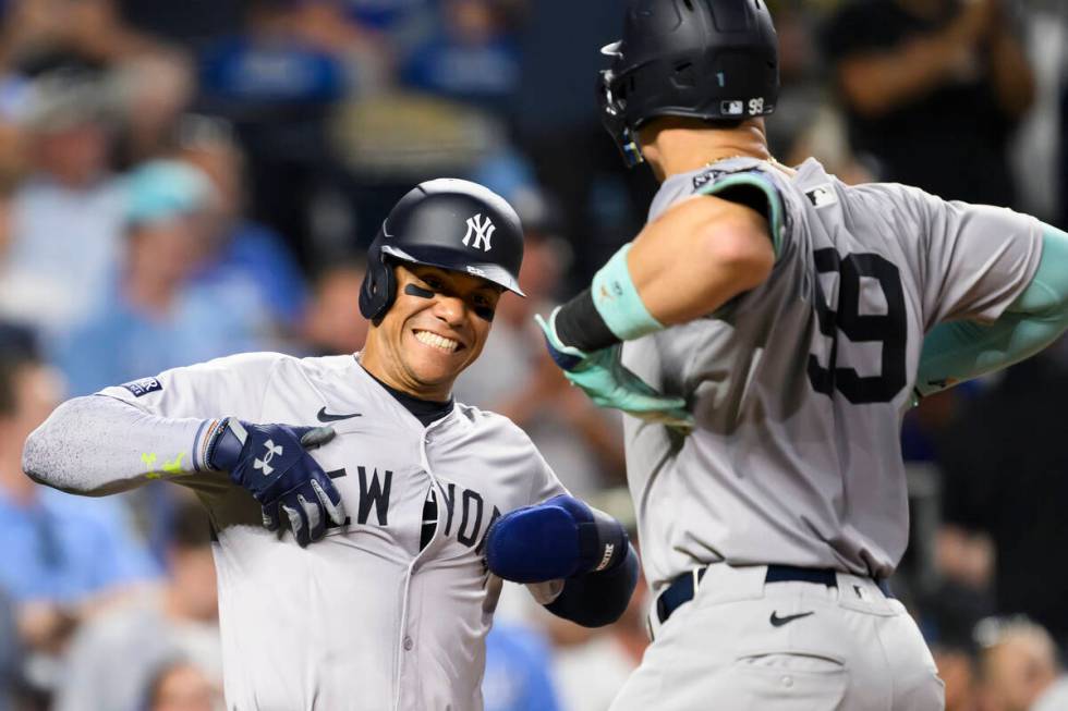 New York Yankees' Juan Soto, left, celebrates with New York Yankees' Aaron Judge (99) after Jud ...