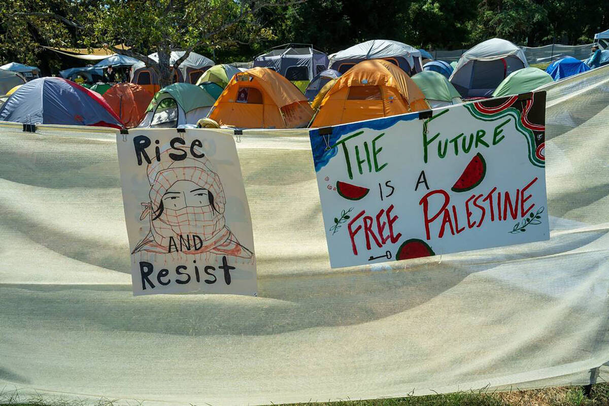 Signs mark the edge of the UC Davis encampment for the Davis Popular University for the Liberat ...