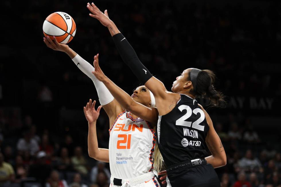 Connecticut Sun guard DiJonai Carrington (21) shoots against Las Vegas Aces center A'ja Wilson ...