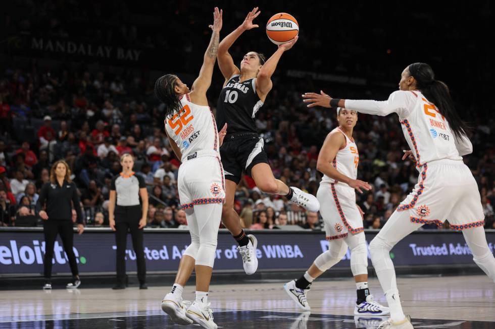 Las Vegas Aces guard Kelsey Plum (10) shoots against Connecticut Sun guard Tyasha Harris (52) d ...