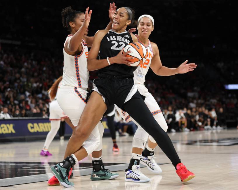 Las Vegas Aces center A'ja Wilson (22) tangles while dribbling against Connecticut Sun forward ...