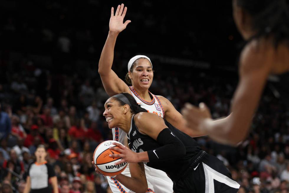 Las Vegas Aces center A'ja Wilson (22) powers toward the hoop against Connecticut Sun forward B ...