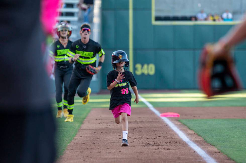 A young fan that hit the homerun of the game runs toward home base during the game between the ...