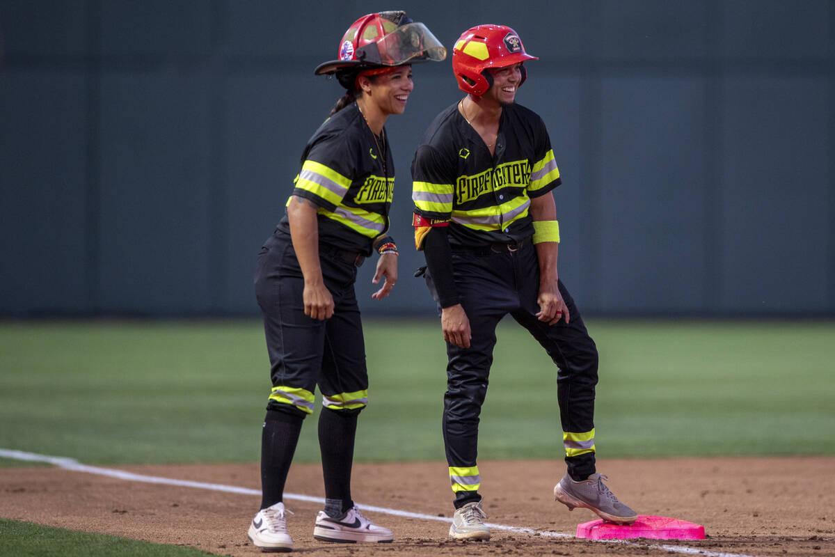 Firefighters’ Head Coach Valerie Perez, left, talks to a teammate during the game agains ...