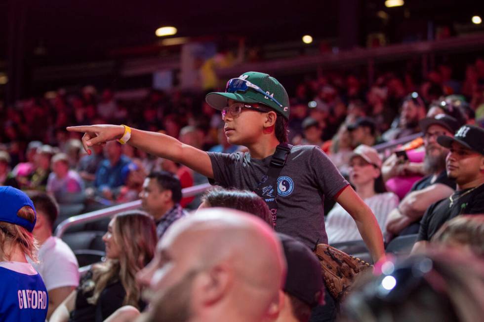 A young fan points out a missed call during the game between the Party Animals and the Firefigh ...