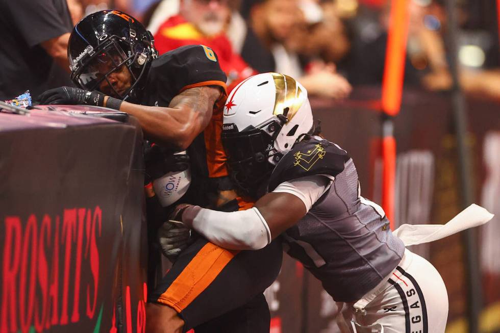 Vegas Knight Hawks defensive back Darius Williams (21) tackles Arizona Rattlers wide receiver C ...