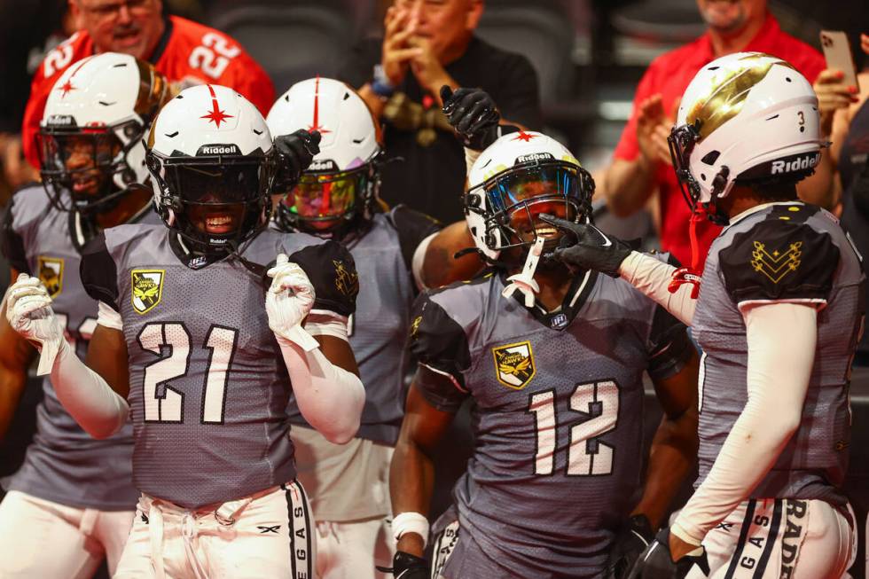 The Vegas Knight Hawks celebrate after defensive back James Ceasar (12) caught an interception ...