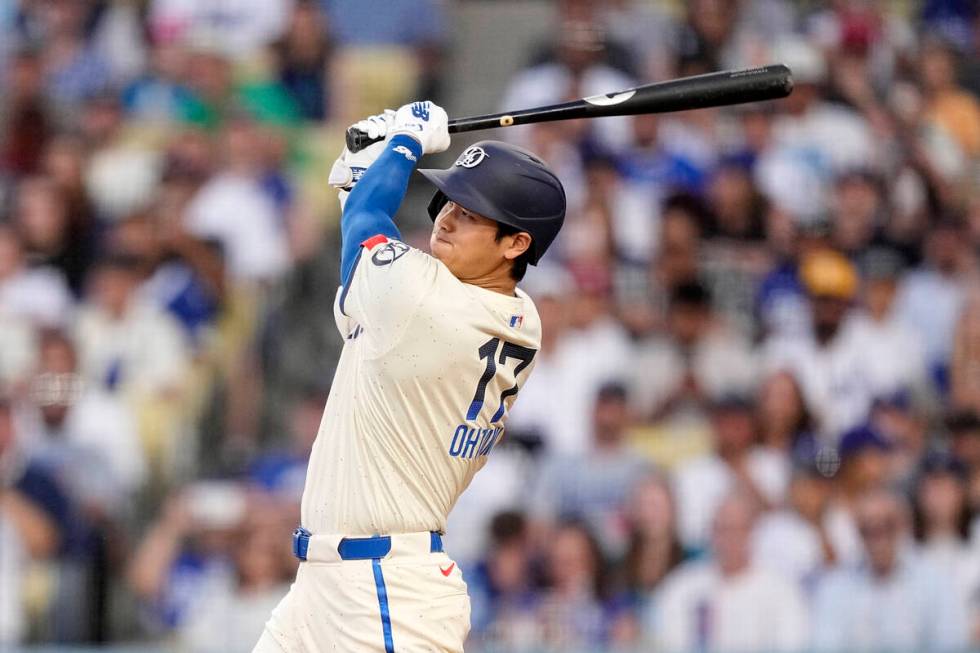 Los Angeles Dodgers' Shohei Ohtani follows through for a two-run home run during the third inni ...