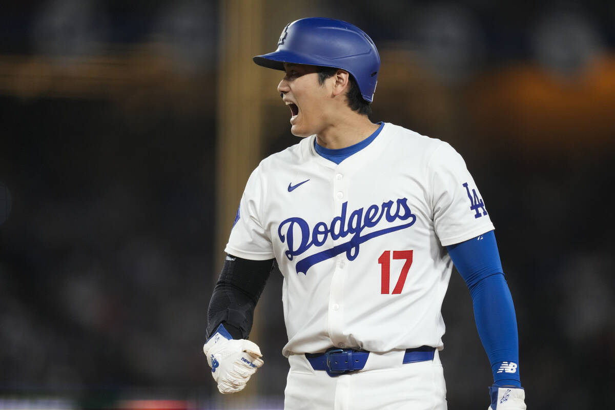 Los Angeles Dodgers designated hitter Shohei Ohtani stands on first during the eighth inning of ...