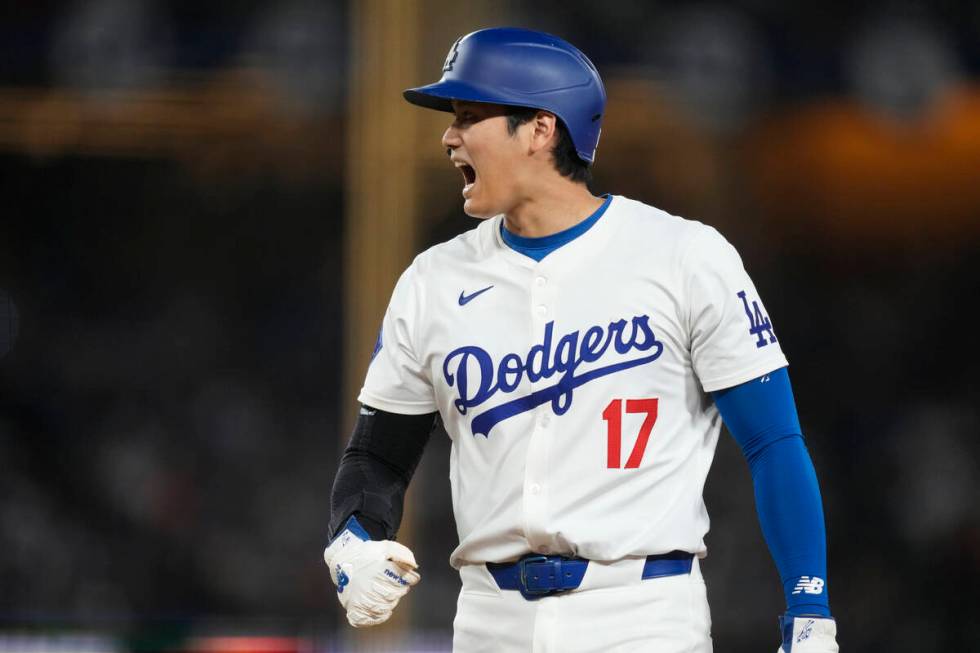Los Angeles Dodgers designated hitter Shohei Ohtani stands on first during the eighth inning of ...