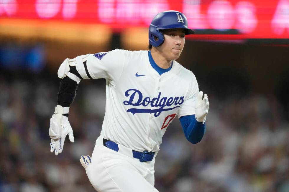Los Angeles Dodgers designated hitter Shohei Ohtani singles during the eighth inning of a baseb ...