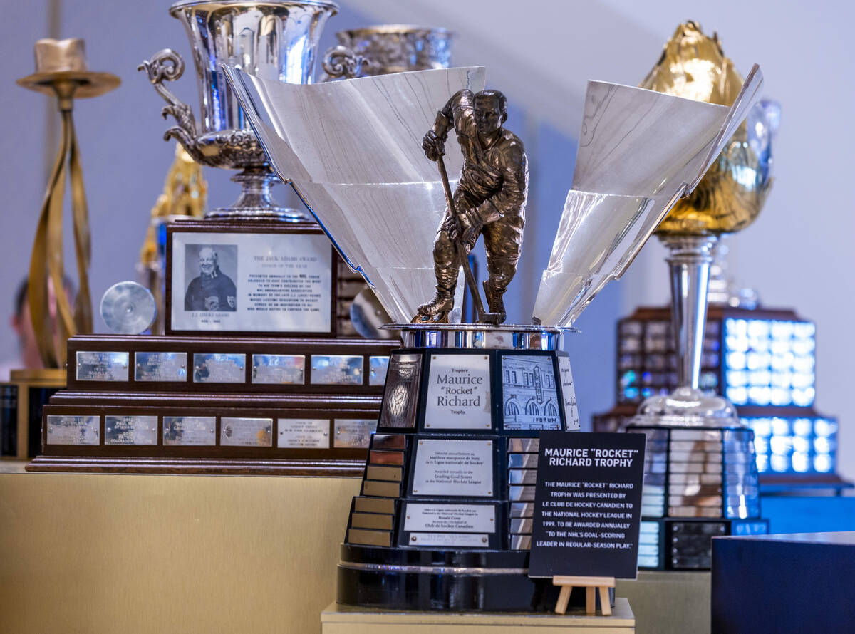 The Maurice "Rocket" Richard Trophy, center, is one the 18 NHL trophies on display as ...