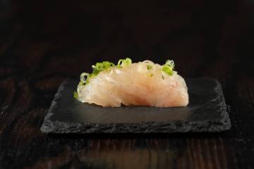 Japanese sea bream with sesame chili ponzu, lemon, sea salt and scallions is being served at th ...