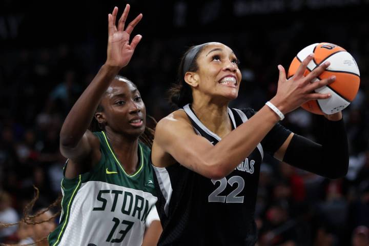 Las Vegas Aces center A'ja Wilson (22) shoots while Seattle Storm center Ezi Magbegor (13) can& ...