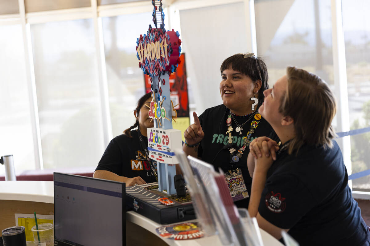 Staff members of The Neon Museum check out a miniature replica of the Stardust marquee, built b ...
