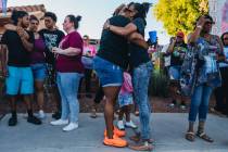 Mourners hug during a vigil for Kayla Harris, who was killed in a quintuple homicide on June 24 ...