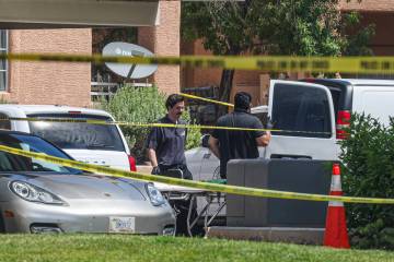 North Las Vegas police investigate the scene where five people were found dead in an apartment ...