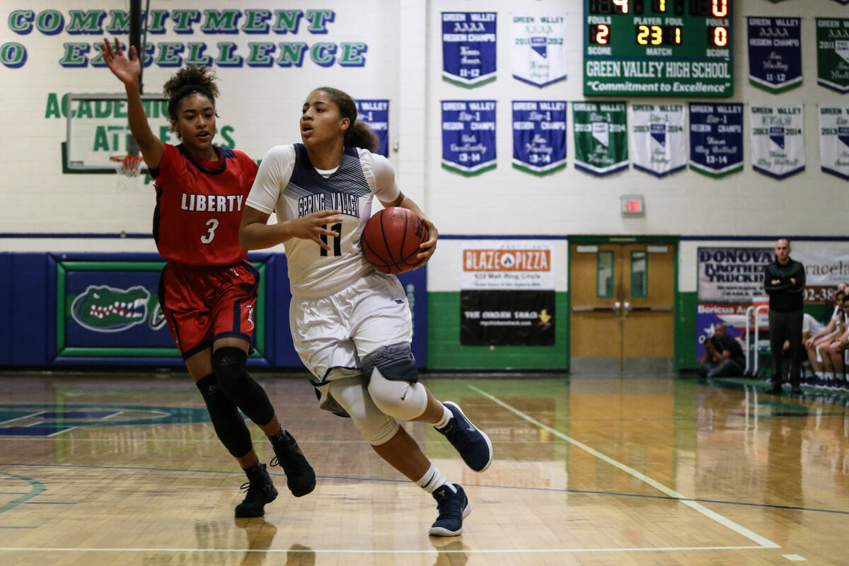 Liberty's Journie Augmon (3) guards Spring Valley’s Kayla Harris (11) during the first q ...