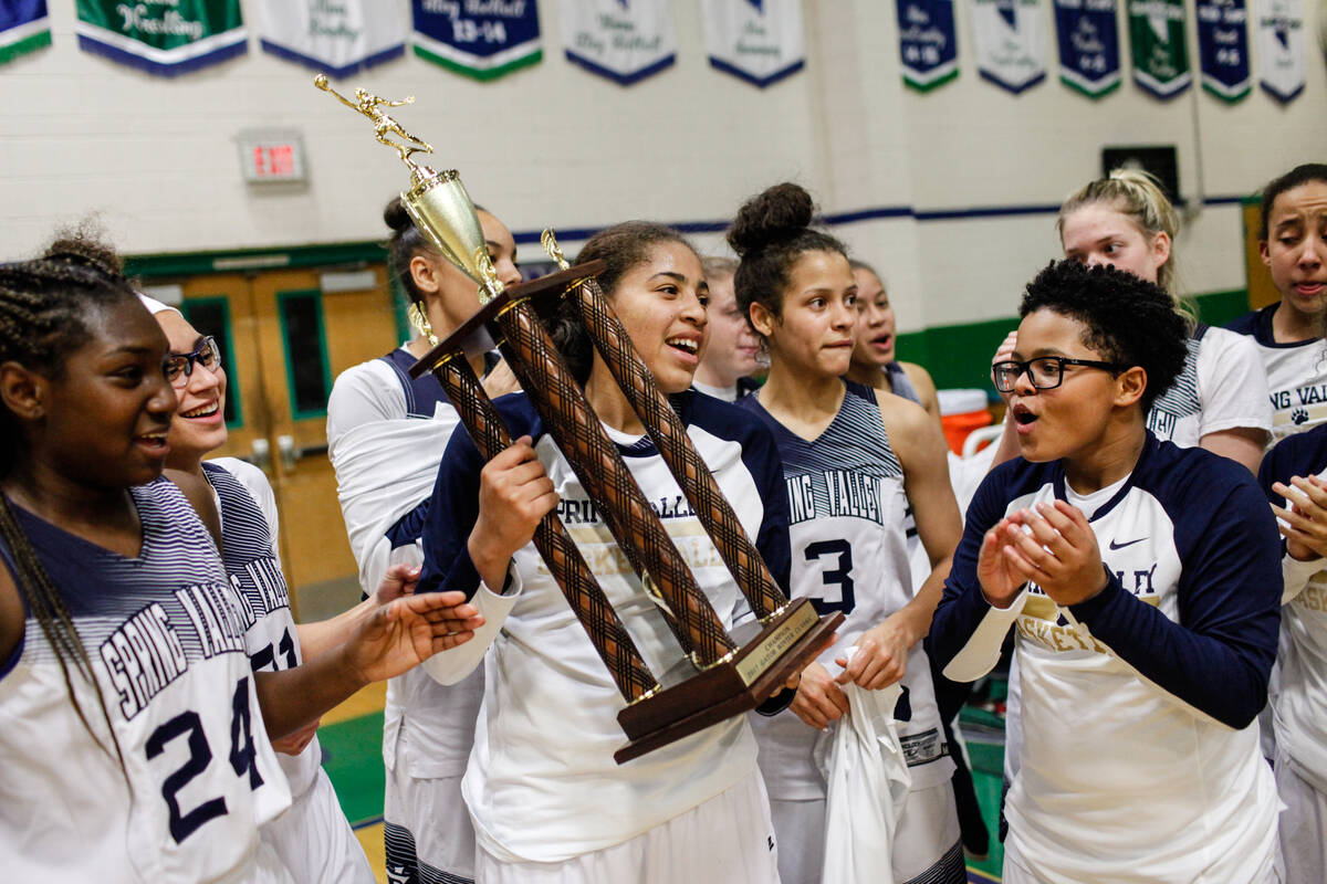 Spring Valley’s Kayla Harris (11) holds the championship trophy after defeating Liberty ...