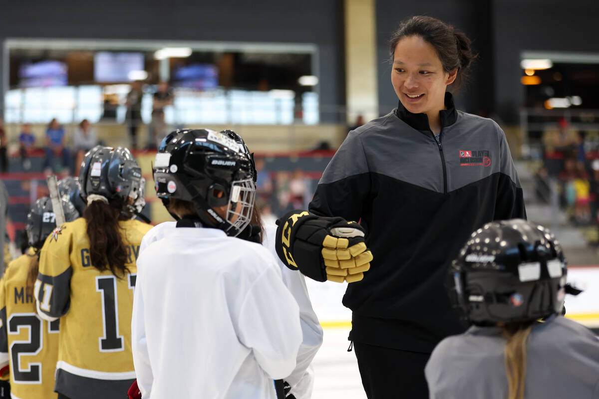 Julie Chu, a former professional hockey player, coaches young attendees during the NHL Draft Pr ...