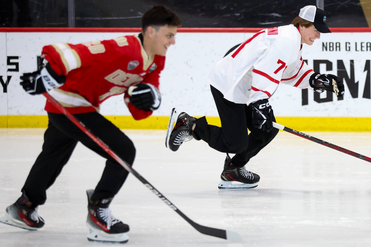 Top potential NHL Draft picks Zeev Buium, left, and Macklin Celebrini race on the ice during th ...