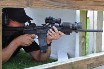 A police officer takes aim from a covered position during training. (Getty Images)